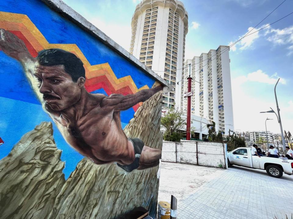 A mural shows a cliff diver.