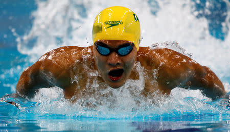 FILE PHOTO: Australia's Kenneth To competes in the men's 100m individual medley heats during the FINA Swimming World Cup 2012 in Dubai, October 2, 2012. REUTERS/Jumana ElHeloueh