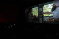 A media person reports from inside the first multiplex cinema of Kashmir in Srinagar in Srinagar, Indian controlled Kashmir, Tuesday, Sept. 20, 2022. The multi-screen cinema hall has opened in the main city of Indian-controlled Kashmir for public for the first time in 14 years. The 520-seat hall with three screens opened on Saturday, Oct. 1, amid elaborate security but only about a dozen viewers lined up for the first morning show. (AP Photo/Dar Yasin)