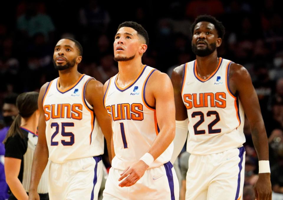 Oct 27, 2021; Phoenix, Arizona, USA; Phoenix Suns guard Devin Booker (1) and center Deandre Ayton (22) against the Sacramento Kings at Footprint Center.