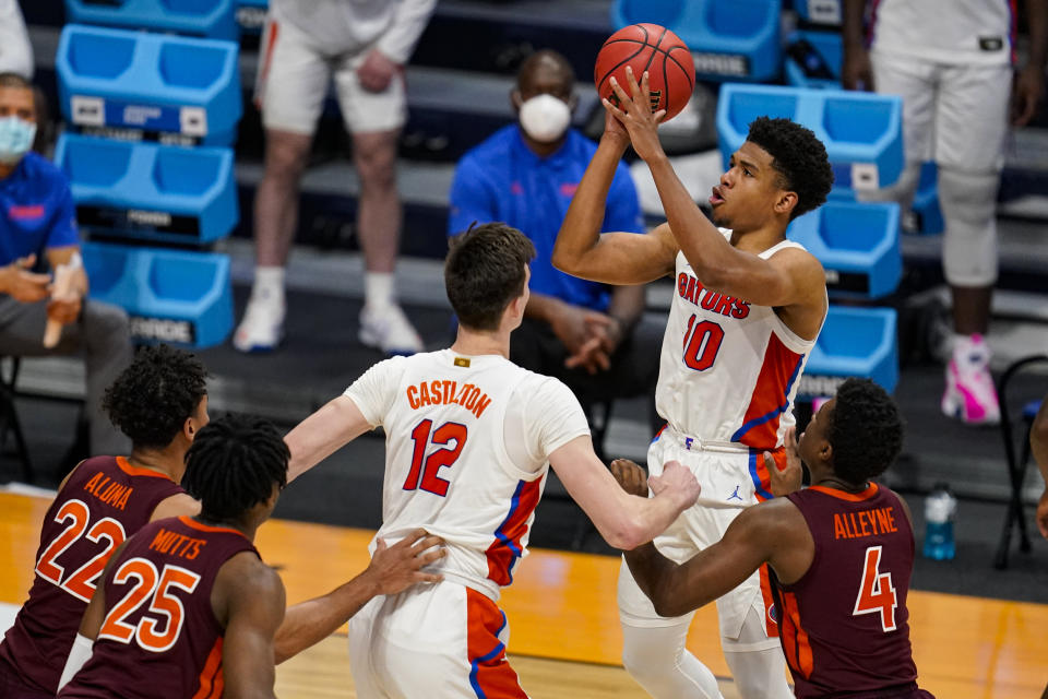 Florida guard Noah Locke (10) shoots against Virginia Tech in the second half of a first round game in the NCAA men's college basketball tournament at Hinkle Fieldhouse in Indianapolis, Friday, March 19, 2021. (AP Photo/Michael Conroy)