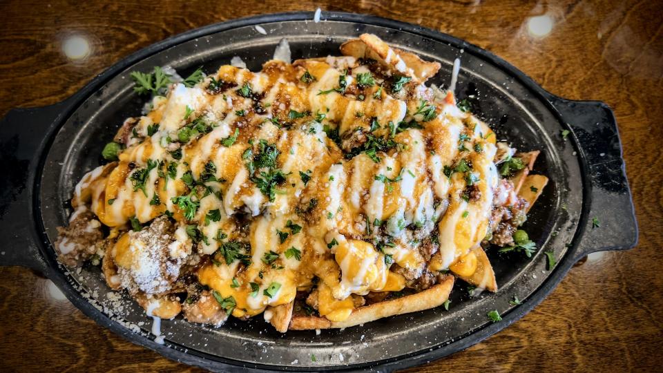 The shepherd’s fries at McCracken's offers a heap of thick-cut fries topped with Shepherd’s pie mix, beer cheese, house-made Guinness glaze and parsley.