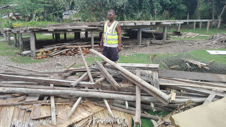 A man stands near the ruins of a house damaged by an earthquake at Malaita province on the Solomon Islands in a handout photo December 9, 2016. Solomon Islands Red Cross/Handout via REUTERS