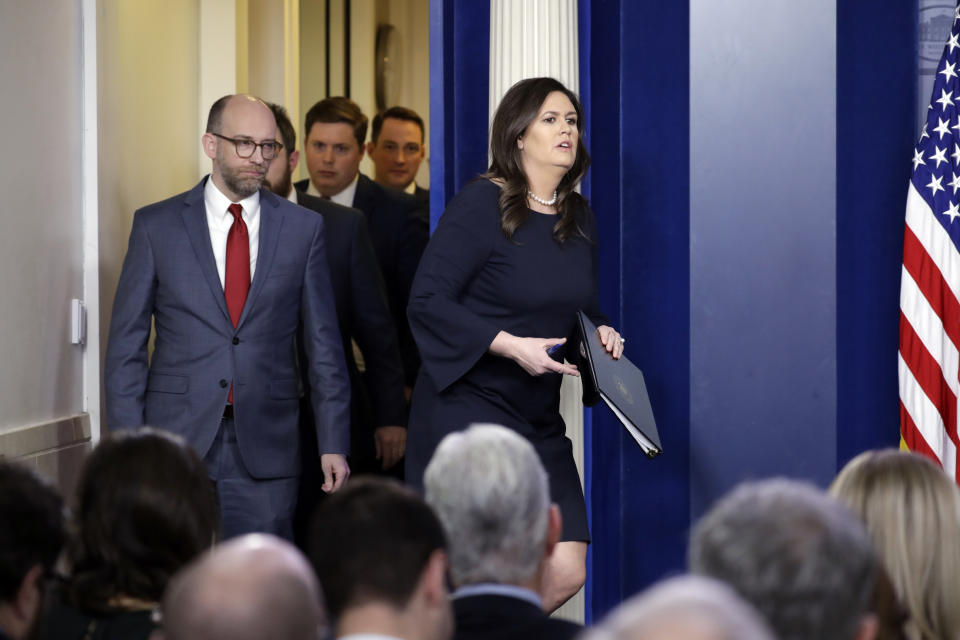 White House press secretary Sarah Sanders walks in with Acting OMB Director Russ Vought speaks during a press briefing at the White House, Monday, March 11, 2019, in Washington. (AP Photo/ Evan Vucci)