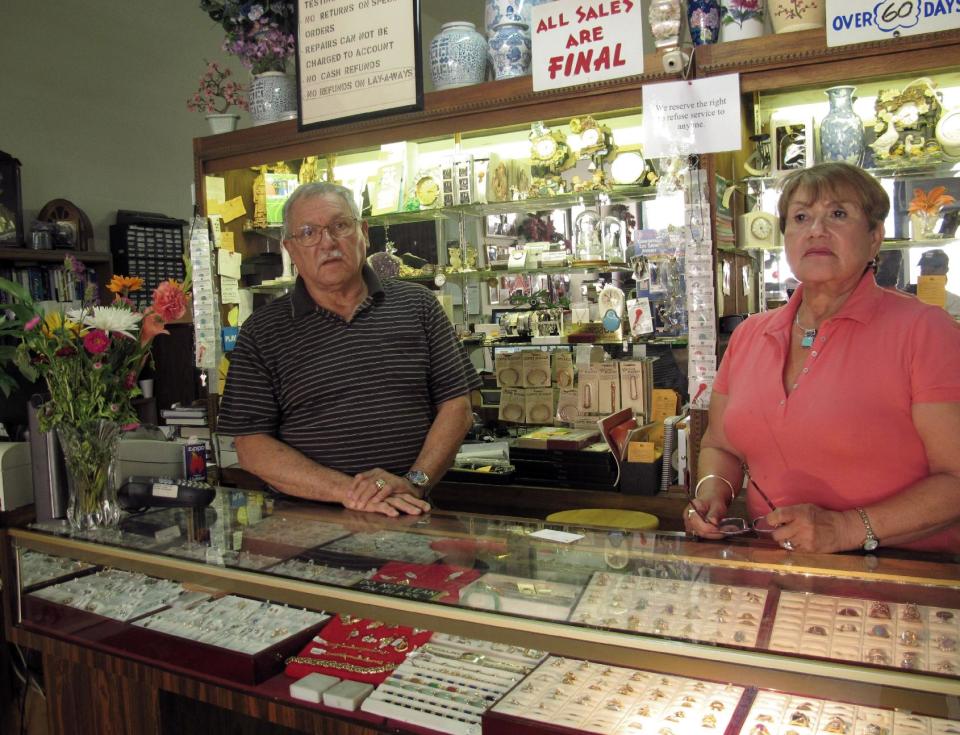 Guillermo and Betty Garcia stand in their downtown Stockton, Calif., clock and jewelry shop Wednesday, June 27, 2012. Garcia said the Stockton bankruptcy will have a trickle effect on residents and business owners, including a rise in crime and more businesses going belly up. (AP Photo/Gosia Wozniacka)