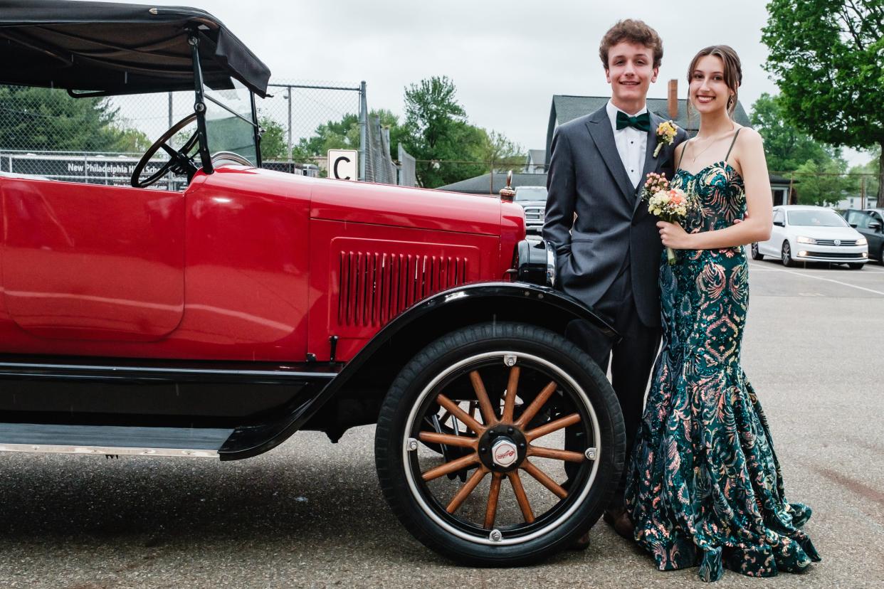 A 1924 Willy's Overland, owned by Charles Scott was used by Kate Scott, right, and her date, Gabe Winn during New Philadelphia High School's prom, Saturday, May 4.