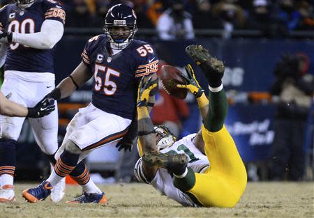 Dec 29, 2013; Chicago, IL, USA; Green Bay Packers tight end Andrew Quarless (81) attempts to make a catch against Chicago Bears outside linebacker Lance Briggs (55) during the fourth quarter at Soldier Field. The Green Bay Packers win 33-28. Mandatory Credit: Mike DiNovo-USA TODAY Sports