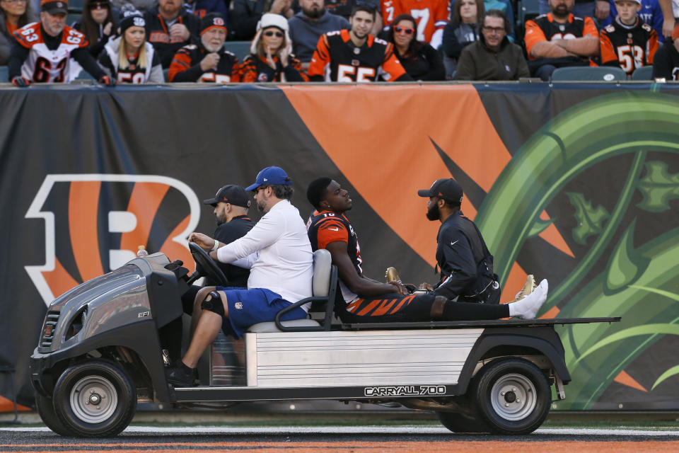 Cincinnati Bengals wide receiver A.J. Green, center, reacts as he is carted off the field after sustaining an injury in the first half of an NFL football game against the Denver Broncos, Sunday, Dec. 2, 2018, in Cincinnati. (AP Photo/Gary Landers)