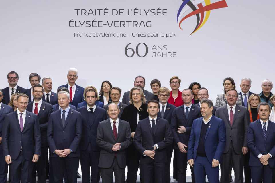 French President Emmanuel Macron, center right, Chancellor of Germany Olaf Scholz, center left, pose with members of their respective cabinets for a group photo ahead of a Franco-German Ministers' council meeting as part of the celebrations marking the 60th anniversary of the Elysee Treaty, at the Elysee Palace in Paris, Sunday, Jan. 22 2023. France and Germany are seeking to overcome differences laid bare by Russia's war in Ukraine and shore up their alliance with a day of ceremonies and talks Sunday on Europe's security, energy and other challenges. (Christophe Petit Tesson, Pool via AP)