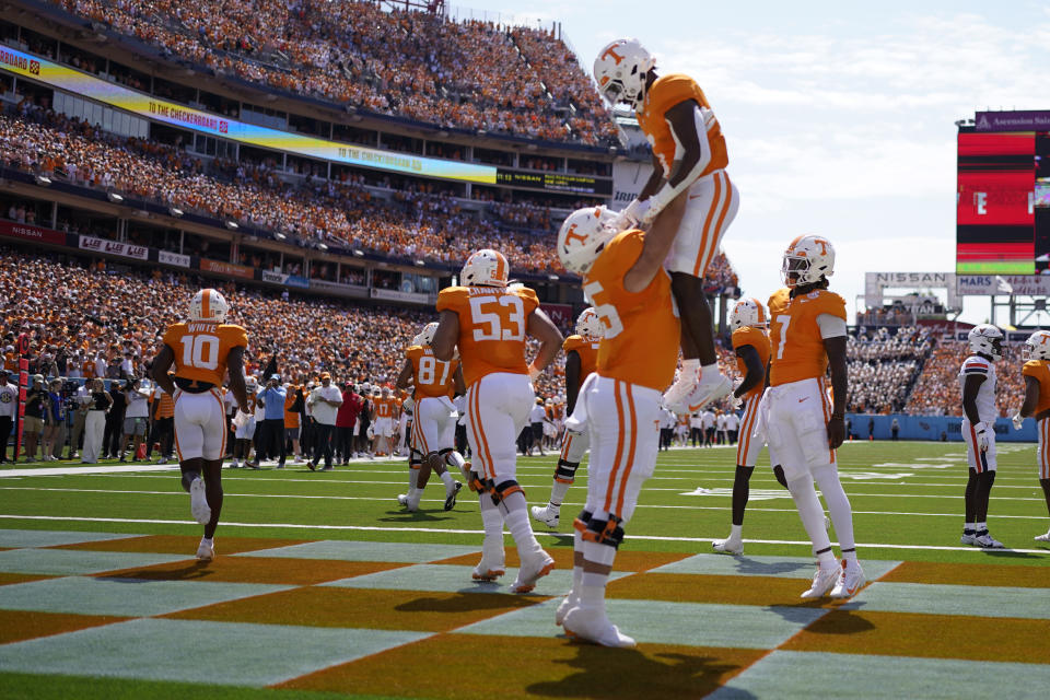 Tennessee offensive lineman Parker Ball lifts running back Dylan Sampson into the air after scoring a touchdown against Virginia in the first half of an NCAA college football game Saturday, Sept. 2, 2023, in Nashville, Tenn. (AP Photo/George Walker IV)