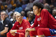 Team USA center Brittany Griner, right, and guard Diana Taurasi, center, watch play during the second half of an NCAA college basketball exhibition game against Tennessee, Sunday, Nov. 5, 2023, in Knoxville, Tenn. (AP Photo/Wade Payne)