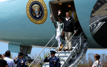 U.S. President Donald Trump and first lady Melania Trump arrive aboard Air Force One, to survey hurricane damage, at Muniz Air National Guard Base in Carolina, Puerto Rico, U.S. October 3, 2017. REUTERS/Jonathan Ernst
