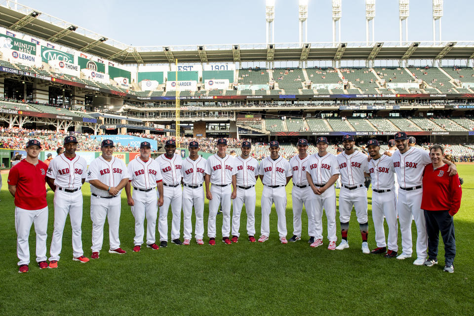 CLEVELAND, OH - JULY 09: Video Coordinator JT Watkins, first base coach Tom Goodwin, bullpen coach Craig Bjornson, pitching coach Dana LeVangie, third base coach Carlos Febles, bullpen catcher Mani Martinez, bench coach Ron Roenicke, coach Ramon Vazquez, manager Alex Cora, assistant hitting coach Andy Barkett, hitting coach Tim Hyers, Xander Bogaerts #2, Mookie Betts #50, J.D. Martinez #28, and video coordinator Billy Broadbent of the Boston Red Sox pose for a group photograph before the 2019 MLB All-Star Game at Progressive Field on July 9, 2019 in Cleveland, Ohio. (Photo by Billie Weiss/Boston Red Sox/Getty Images)