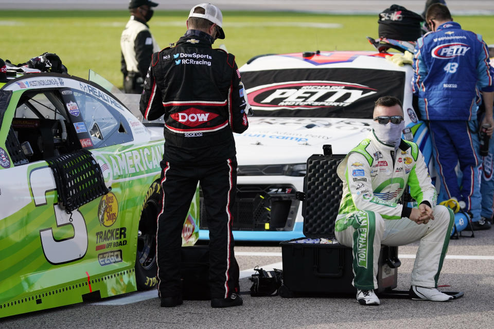 Driver Austin Dillon sits next to his car before a NASCAR Cup Series auto race at Kansas Speedway in Kansas City, Kan., Thursday, July 23, 2020. (AP Photo/Charlie Riedel)