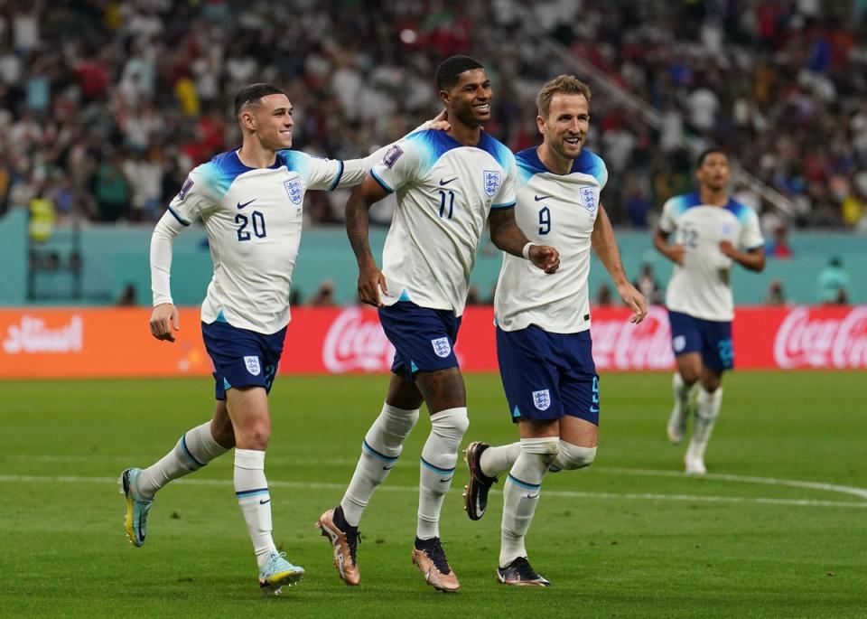 England’s Marcus Rashford (centre) celebrates with Phil Foden (left) and Harry Kane after scoring their side’s fifth goal of the game (PA)