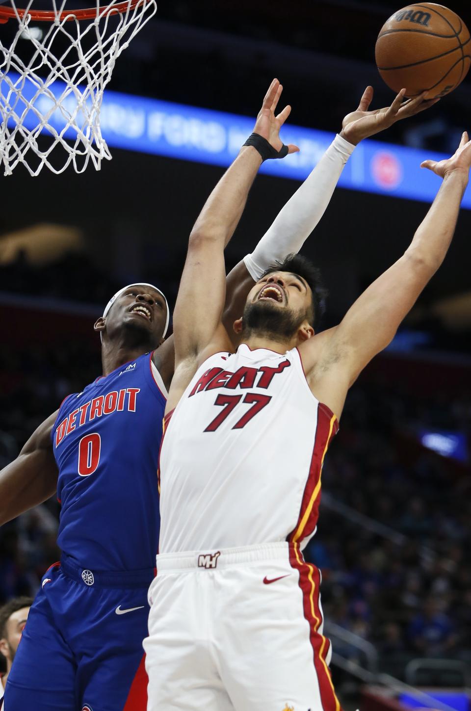 Detroit Pistons center Jalen Duren (0) keeps a rebound away from Miami Heat center Omer Yurtseven (77) during the first half of an NBA basketball game, Sunday, March 19, 2023, in Detroit. (AP Photo/Duane Burleson)