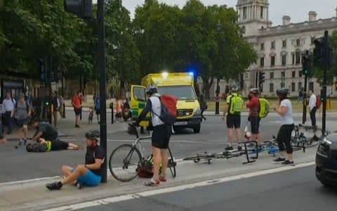 Injured cyclists were seen laying on the ground after being mown down by the Ford Fiesta