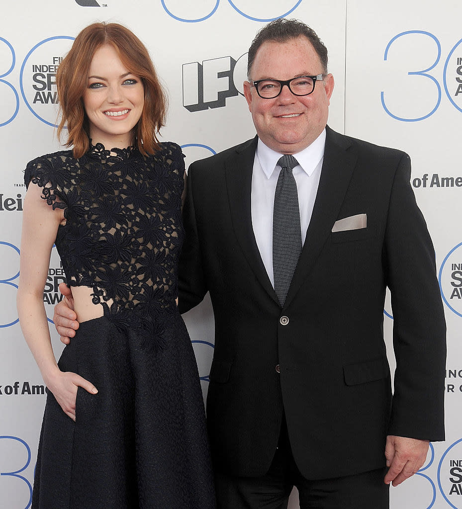 Emma standing with her father on the red carpet