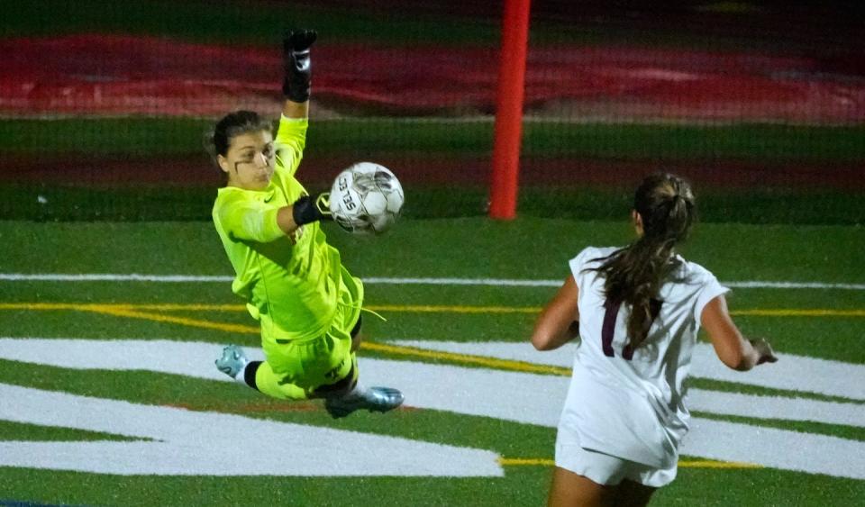 Cranston West goalkeeper Oceanna Orlandi sails through the air to get in front of an East Greenwich shot during the second half on Thursday.
