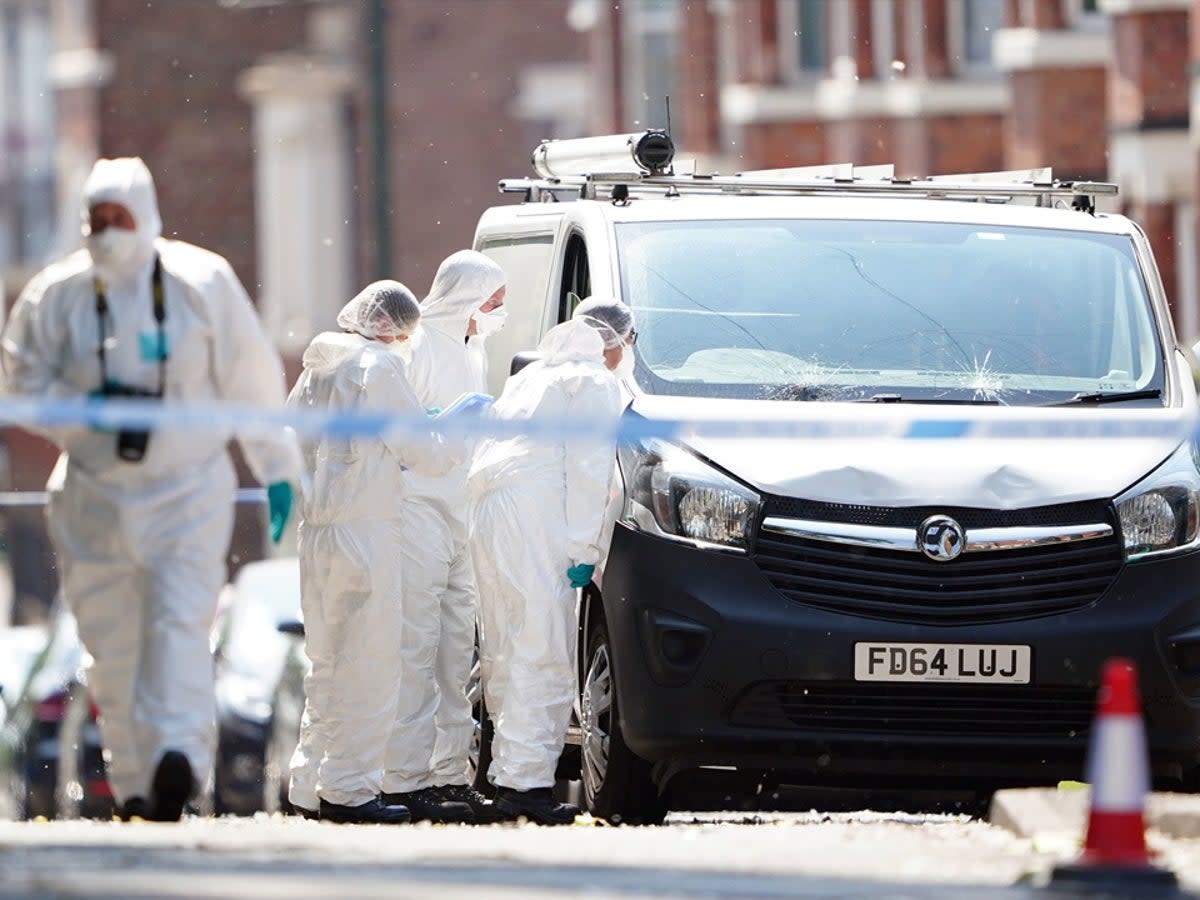 Police forensics officers on Ilkeston Road, Nottingham on Tuesday (PA)