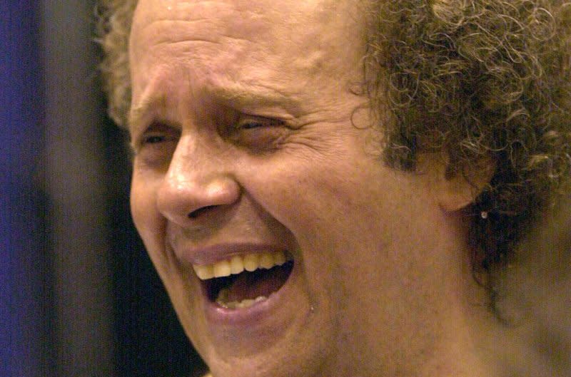 Fitness guru Richard Simmons laughs with the crowds that have come to exercise with him at the Family Expo at the America's Center in 2000. File Photo byBill Greenblatt/UPI