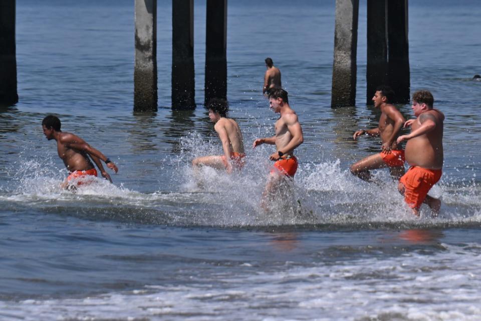 Lifeguards did their morning swimming and running drills during the heat wave on Friday. Paul Martinka