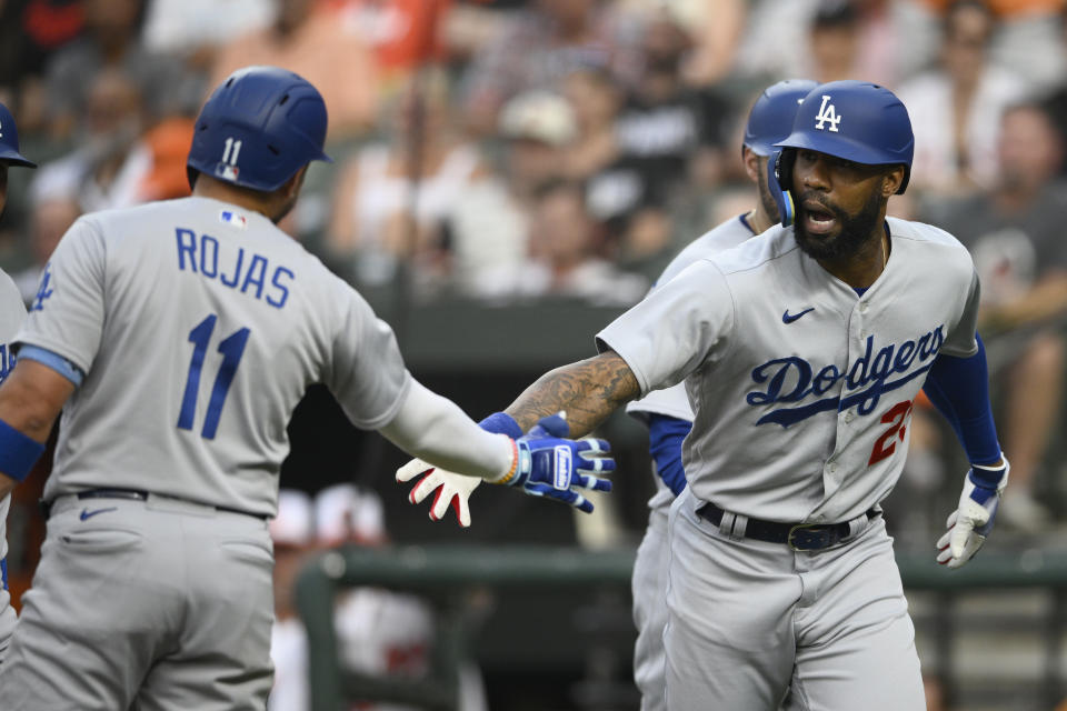 Los Angeles Dodgers' Jason Heyward, right, celebrates his three-run home run with Miguel Rojas (11) during the second inning of a baseball game against the Baltimore Orioles, Tuesday, July 18, 2023, in Baltimore. (AP Photo/Nick Wass)