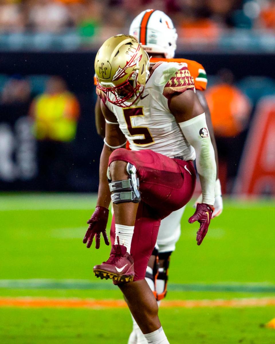 Florida State University defensive end Jared Verse (5) motions as if ‘snapping the U’ after sacking University of Miami quarterback Jacurri Brown (11) during the first half of an ACC football game at Hard Rock Stadium in Miami Gardens on Saturday, November 5, 2022.