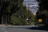 A runaway vehicle sign is posted on a section of Hawthorne Blvd near the site of a car crash involving golfer Tiger Woods, Tuesday, Feb. 23, 2021, in Rancho Palos Verdes, Calif., a suburb of Los Angeles. (AP Photo/Ashley Landis)