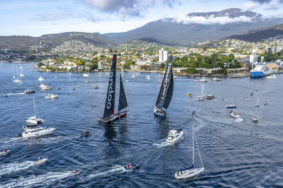 In this photo provided by Rolex/Cruising Yacht Club of Australia, super maxis Comanche, left, and LawConnect duel for the lead near the finish of the Sydney Hobart yacht race in Hobart, Australia, Thursday, Dec. 28, 2023. LawConnect wins the battle to finish to take line honors in the 628-nautical mile race. (Kurt Arrigo/Rolex/CYCA via AP)