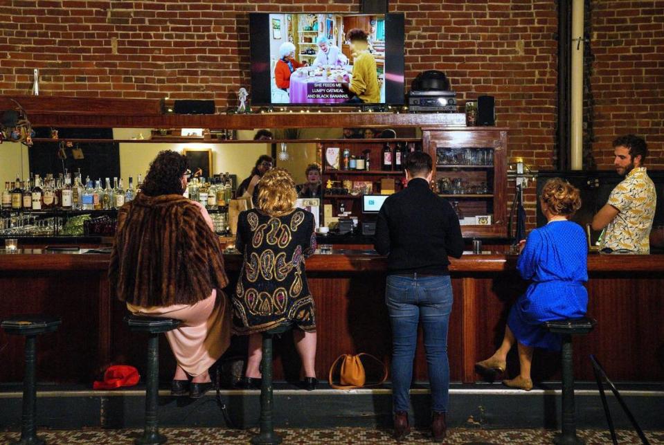 Wayne Moots, from left, Gabi Bailey, Leisha Anderson and 9th & State owner Heather Hamilton, along with bartender Taylor Harlow, gather to watch the “The Golden Girls.” Every Wednesday is Golden Girls Night at the bar.
