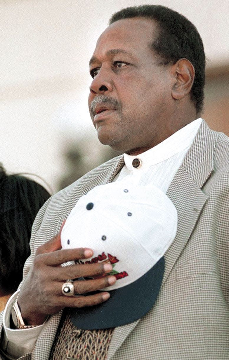 Willie Stargell honors the flag during the 1996 Azalea Festival Parade in Wilmington. Stargell was grand marshall of the parade.