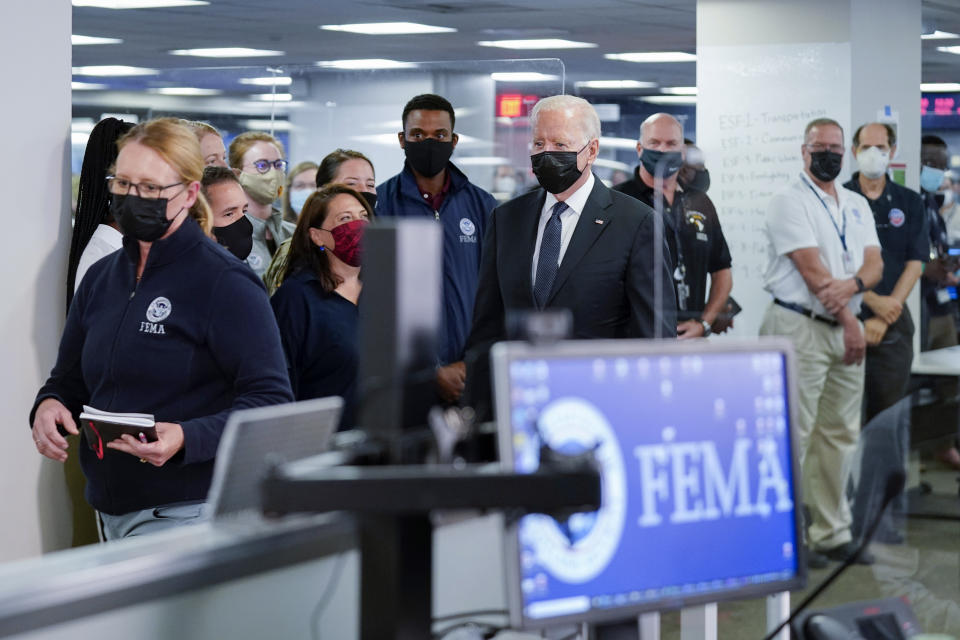 President Joe Biden arrives at the National Response Coordination Center at FEMA headquarters, Sunday, Aug. 29, 2021, in Washington. FEMA Administrator Deanne Criswell is at left. (AP Photo/Manuel Balce Ceneta)