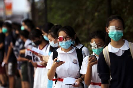 Secondary school students shout slogans as they form a human chain in Hong Kong