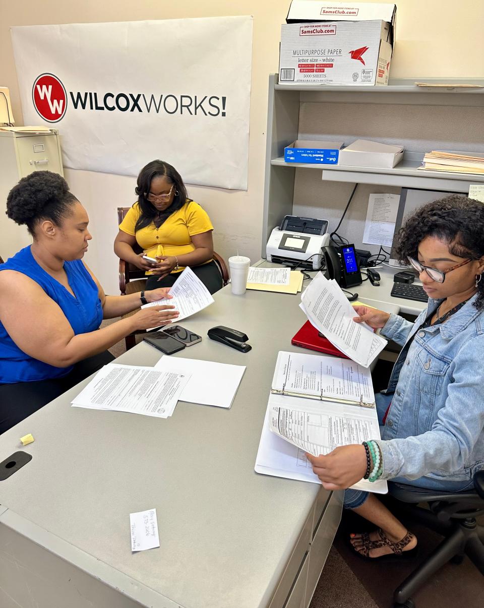 From left, Wilcox Works team members Kierra Jackson, Jaserica Angion and Shanyia Sigler review applications for the a teen employment program.