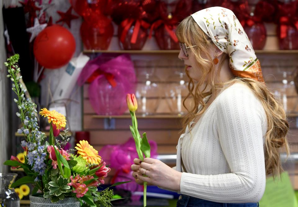 Aleah McKenney-Hartley, co-owner of Botanica Florist in Jackson Township, creates an arrangement from fresh flowers.