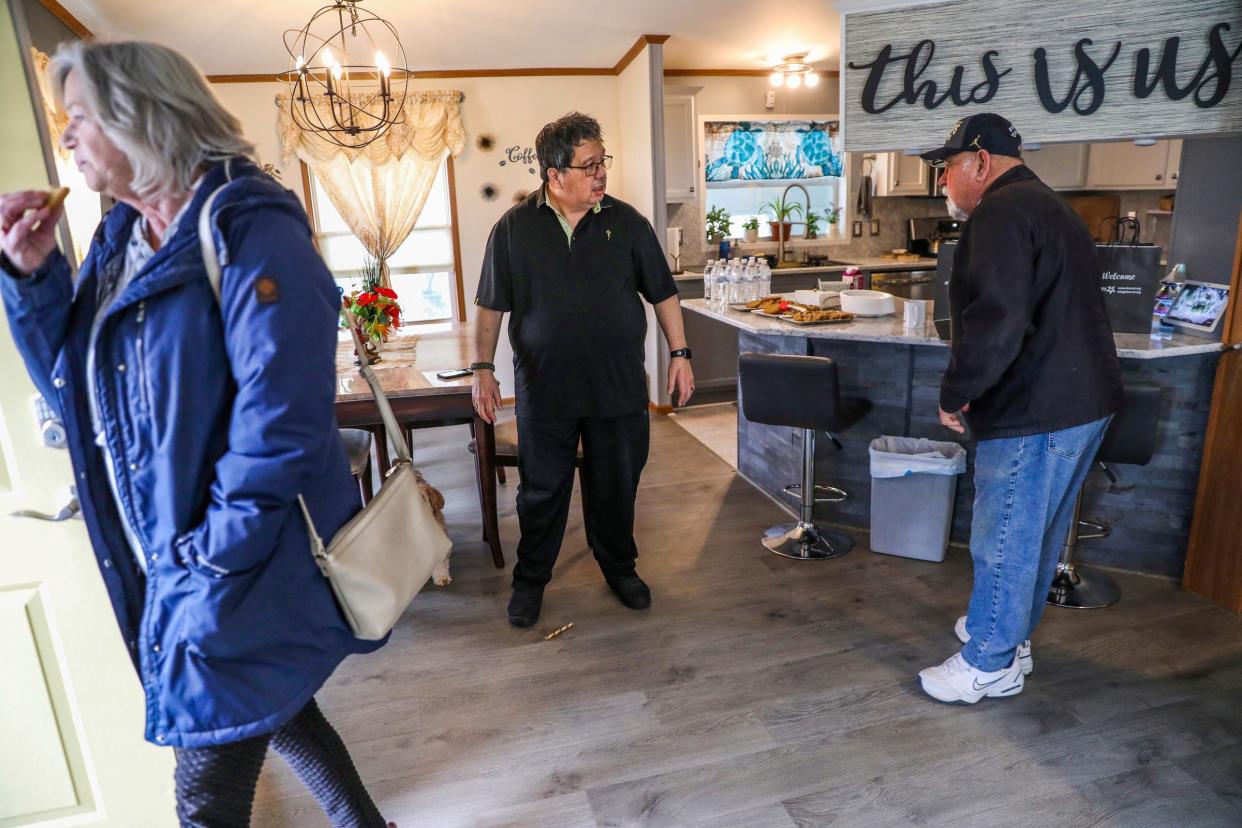 Kimo Keawe, 70, center, president of the Avon on the Lake residents association, hosts a meeting at his home in their mobile home community in Rochester Hills on Wednesday, Feb. 28, 2024. Keawe says goodbye to Sue Lowler, 77, left, and Lou Noce, 74, after the meeting.