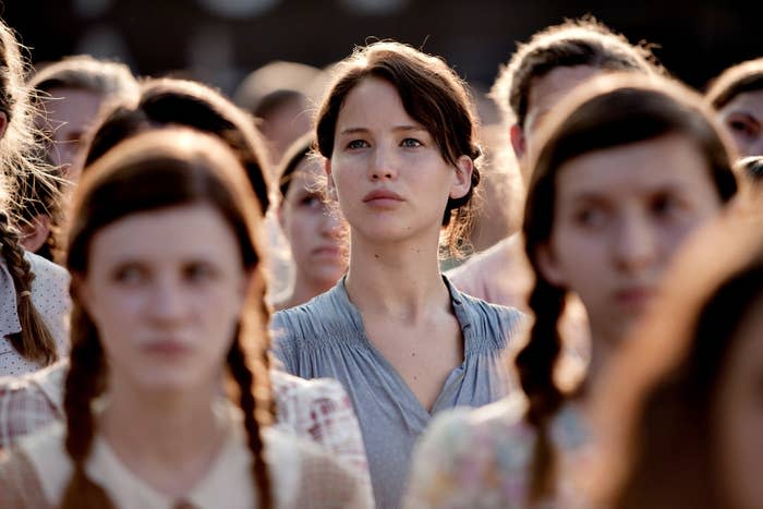 Katniss standing among the crowd from "The Hunger Games"