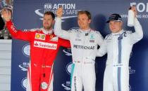 Formula One - Russian Grand Prix - Sochi, Russia - 30/4/16 - Ferrari driver Sebastian Vettel of Germany, Mercedes F1 driver Nico Rosberg of Germany and Williams F1 driver Valtteri Bottas of Finland pose for photographers after the qualifying session. REUTERS/Maxim Shemetov