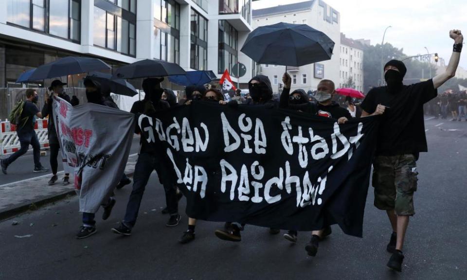 Protesters hold a banner reading ‘Against a city of the rich’