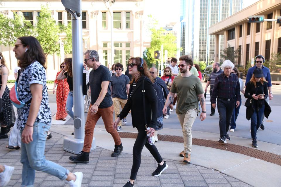 Opening-night attendees walk the path of Oklahoma City Repertory Theatre's "Of a Mind: Oklahoma City," a theatrical guided audio tour through part of downtown OKC. The tour continues at select dates and times through May 29.