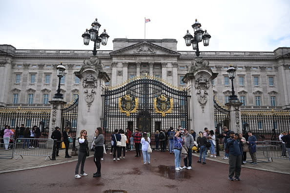 People gather outside Buckingham Palace to focus on the Queen's health (Photo by Leon Neal/Getty Images)