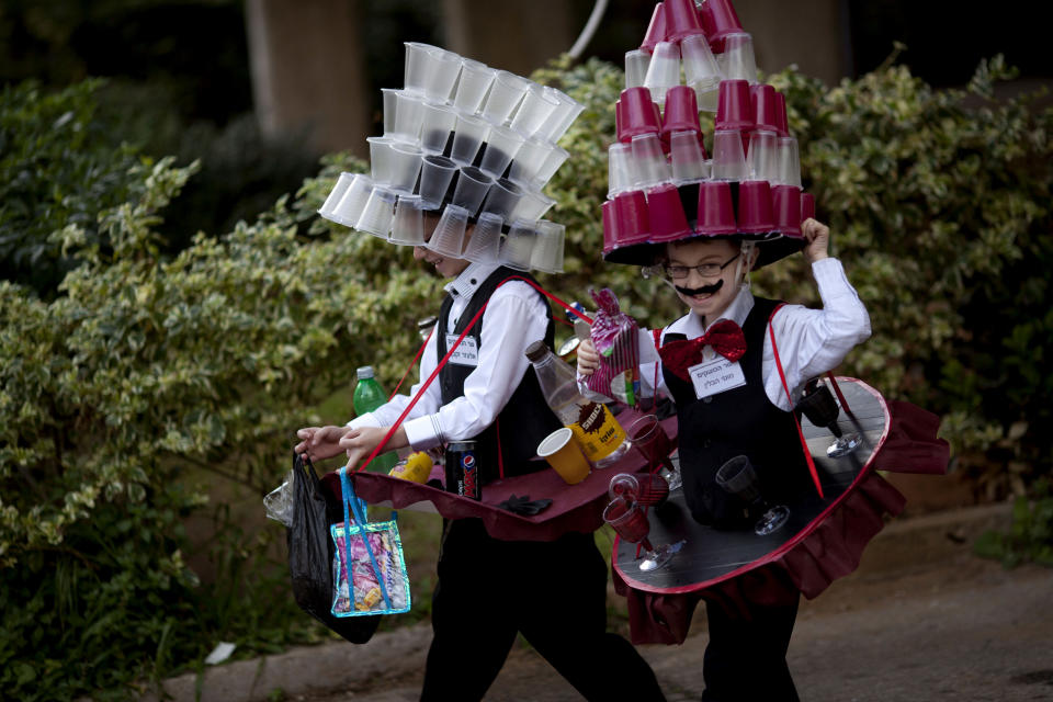 Moti and Elazar, 8, two Ultra Orthodox Jewish boys dressed in costumes walk during the Purim festival in the ultra-Orthodox town of Bnei Brak, Israel,Sunday, Feb. 24, 2013. (AP Photo/Ariel Schalit)