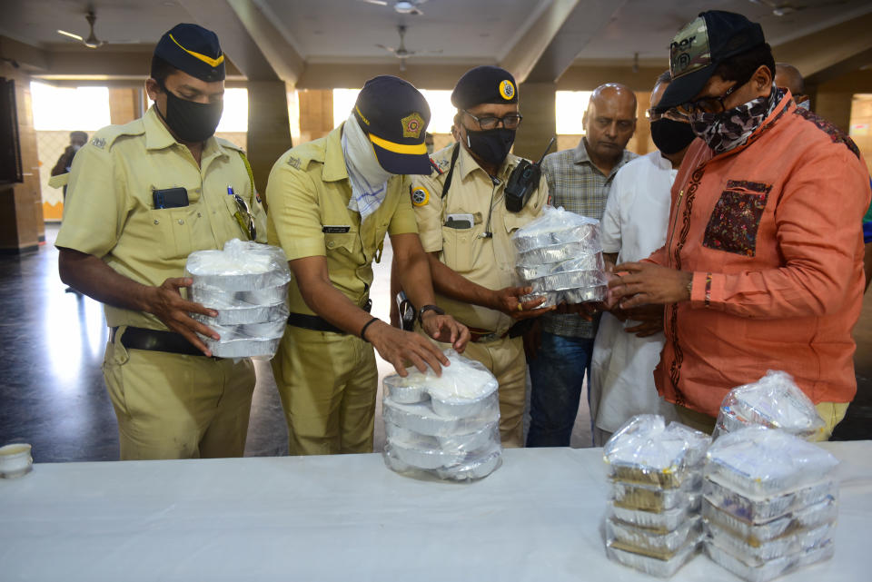 MUMBAI, INDIA - MARCH 26: Food packets being distributed by Kuchhi Visha Oswal Jain Seva, Kurla with support of local corporater Captan Malik for Police, BMC and Hospital Staff during restrications on citizem's movement on account of section 144 due to COVID 19 pandemic, on March 26, 2020 in Mumbai, India. (Photo by Vijayanand Gupta/Hindustan Times via Getty Images)