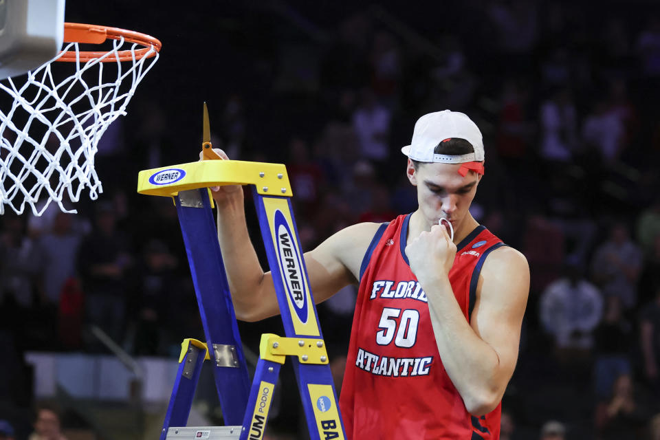 Florida Atlantic Owls center Vladislav Goldin (50) kisses a piece of the net after FAU's Elite Eight win. (Photo: Brad Penner-USA TODAY Sports)