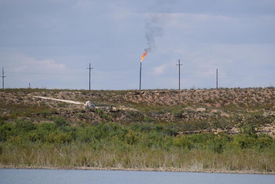 A methane gas flare burns four miles from the Red Bluff Reservoir in Reeves County, Texas on February 24, 2020. NGL Water Solutions Permian has proposed to discharge treated produced water into the reservoir.