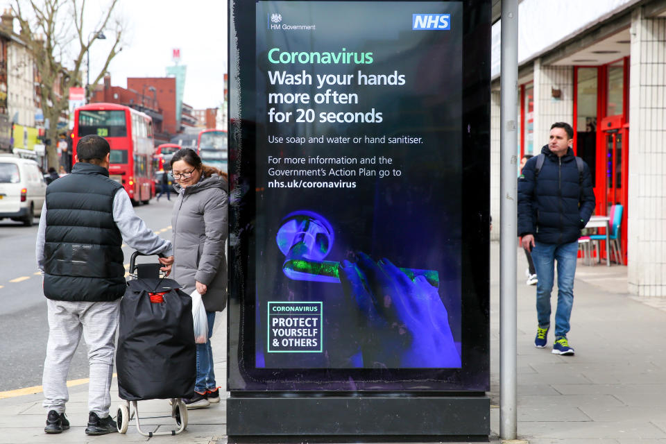 People walk past a Coronavirus public information campaign poster in London, which focuses on hand washing. Five coronavirus victims have died and 319 cases have tested positive for the virus. (Photo by Dinendra Haria / SOPA Images/Sipa USA)