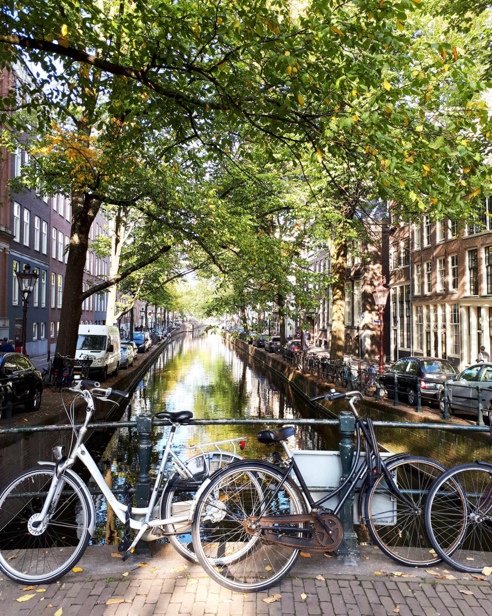 Bikes parked by a canal in Amsterdam.