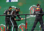 Race winner Mercedes driver Lewis Hamilton of Britain, centre, sprays champagne at the podium with second placed Mercedes driver Valtteri Bottas of Finland, left, and third placed Red Bull driver Max Verstappen of the Netherlandsafter the Formula One Portuguese Grand Prix at the Algarve International Circuit in Portimao, Portugal, Sunday, Oct. 25, 2020. (Rafael Marchante, Pool via AP)