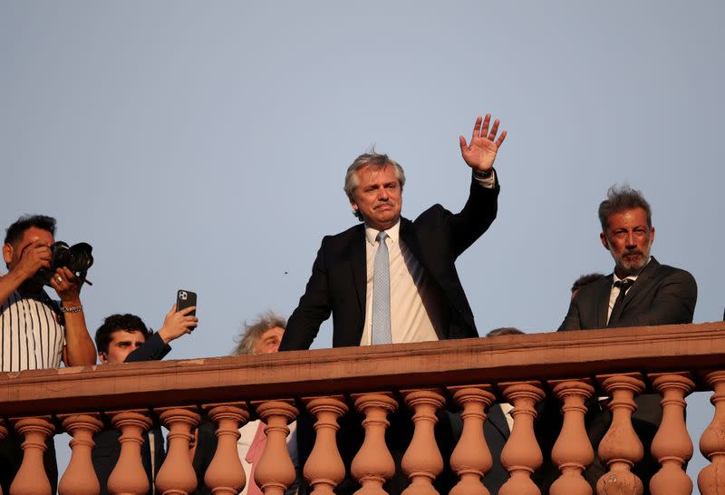 FILE PHOTO: Argentina's President Alberto Fernandez waves from the balcony of the Casa Rosada Presidential Palace after his inauguration, in Buenos Aires